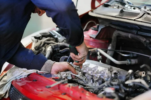 Worker repairs a car