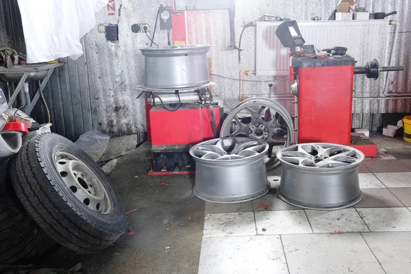 Car wheels in a tyre fitting workshop