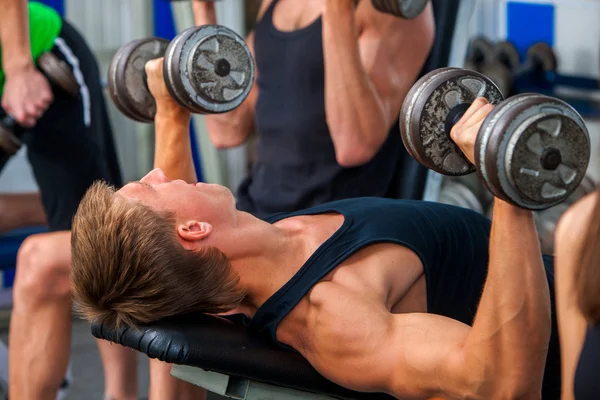 Group of sport men working his body at gym.