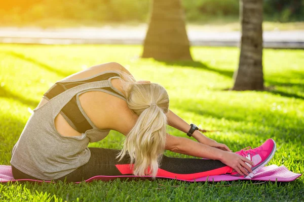 Fitness woman stretching her muscles before training