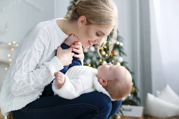 Portrait of happy mother and adorable baby celebrate Christmas.