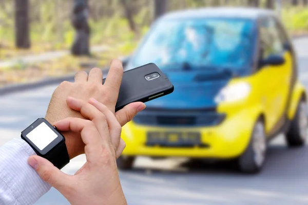 Mans hands with smart watch and mobile phone