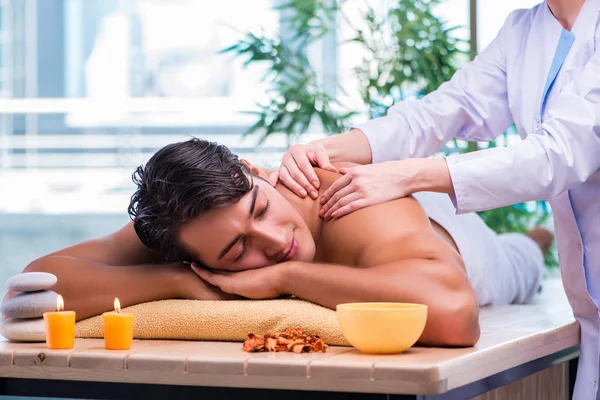 Man during massage session in spa salon