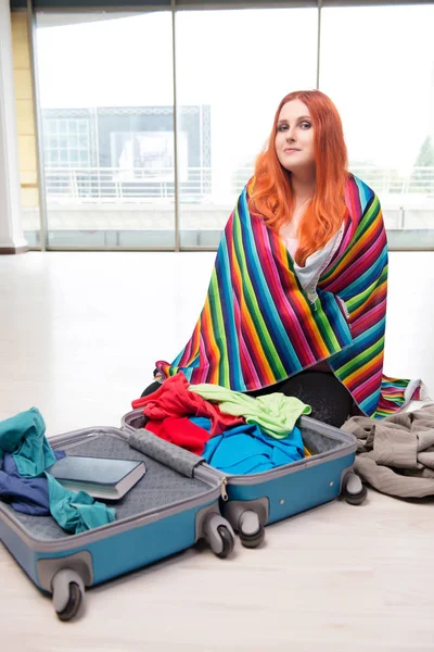 Young woman packing for travel vacation