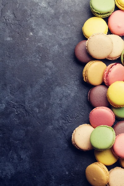 Colorful macarons on stone table