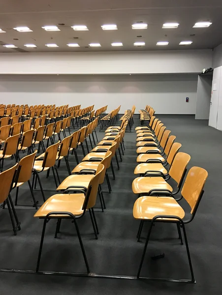 Wooden chairs inside empty meeting room