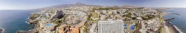 Sunset over Playa de Las Americas, beautiful aerial view of Tene