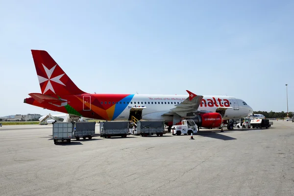 LUQA, MALTA - APRIL 18: The aircraft of Malta Airlines taking maintenance at Malta Airport on April 18, 2015 in Luqa, Malta. More then 1,6 mln tourists is expected to visit Malta in year 2015.