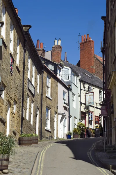 Steep narrow street with houses on either side