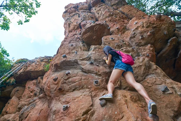 Woman practicing rock climbing