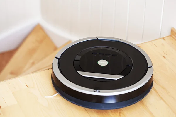 Robotic vacuum cleaner on laminate wood floor smart cleaning tec
