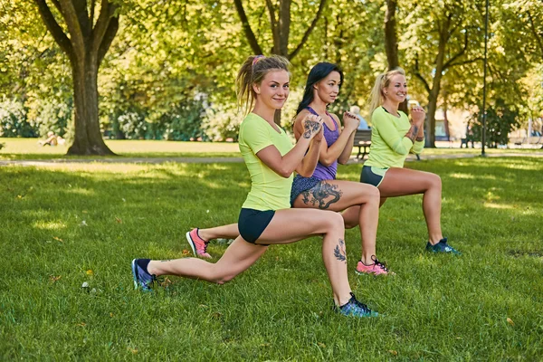 Sporty girls doing squats