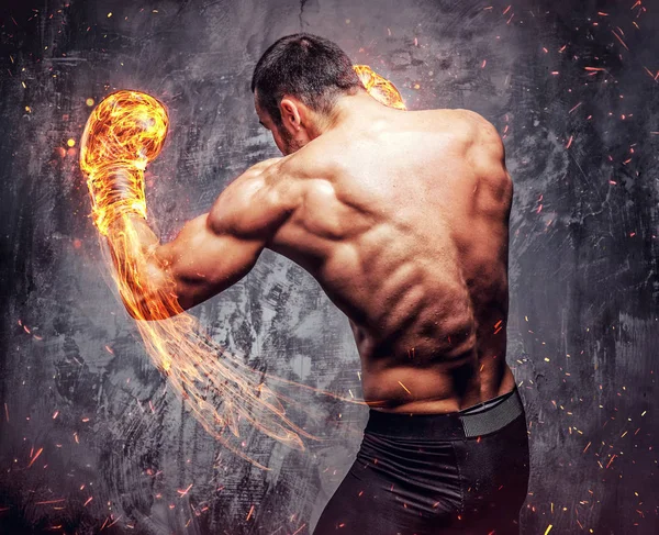 Shirtless fighter with burning boxer gloves.