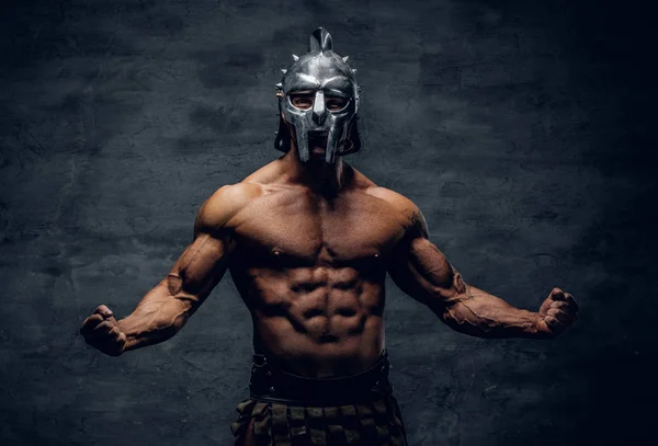 Muscular man in a gladiator silver helmet