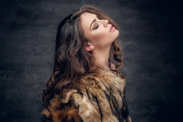 Brunette woman dressed in a warm fur coat