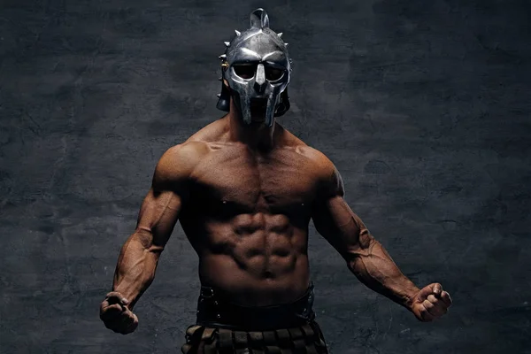 Muscular man in a gladiator silver helmet