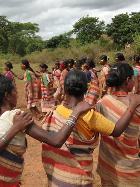Tribal women link arms