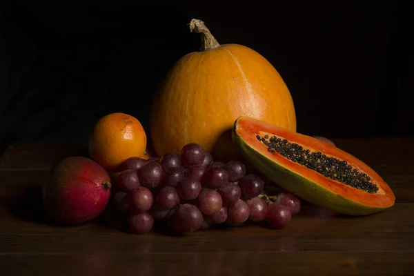 Variety of fruits on a wooden table, studio picture