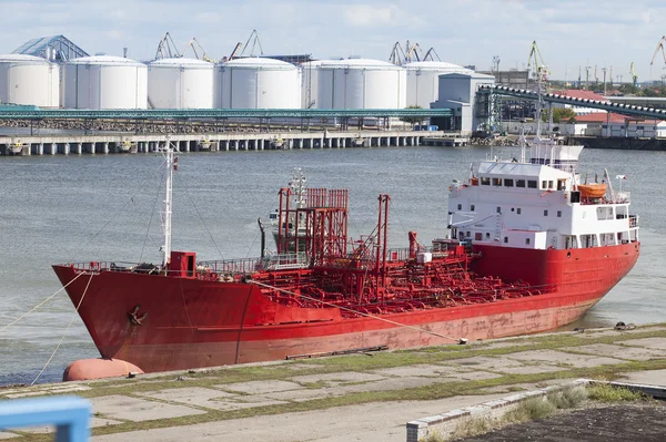 Large red ship docked in the port