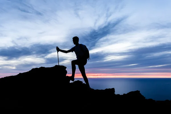 Man hiking silhouette in mountains, ocean and sunset inspiration