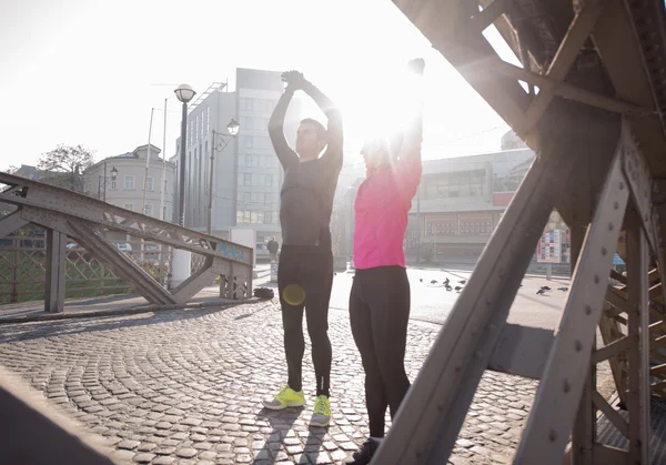 Couple warming up before jogging