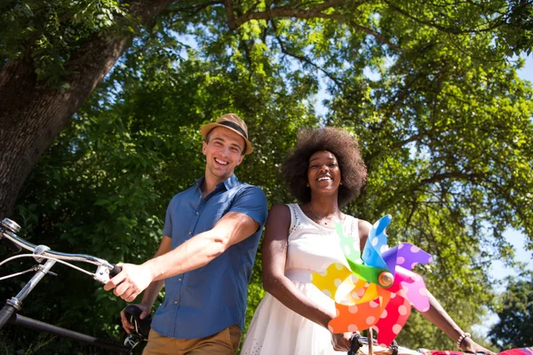 Young multiethnic couple having a bike ride in nature