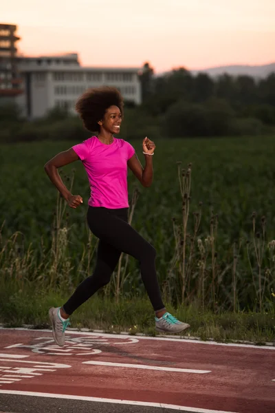 Young African American woman jogging outdoors
