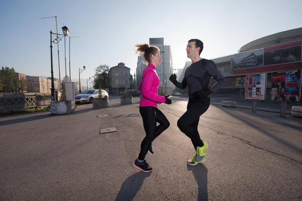 Couple warming up before jogging