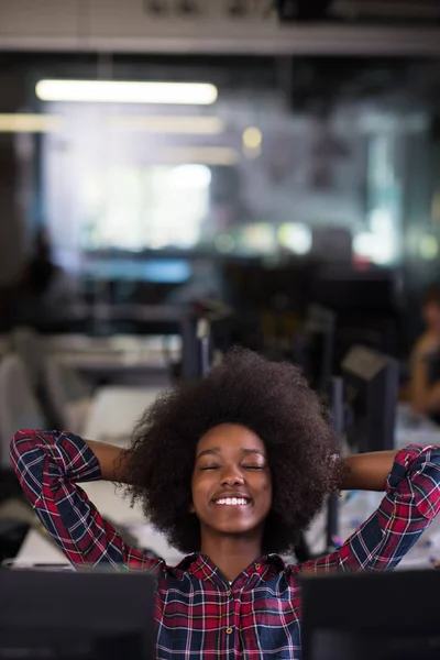Young black woman at her workplace in modern office