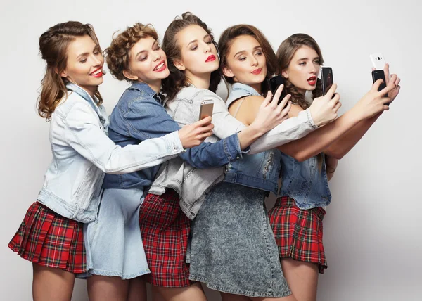 Group of young women looking at their smartphones