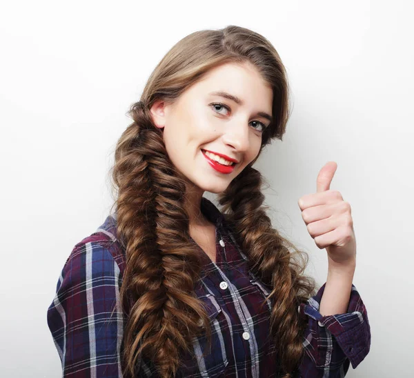 Happy young woman giving thumb up