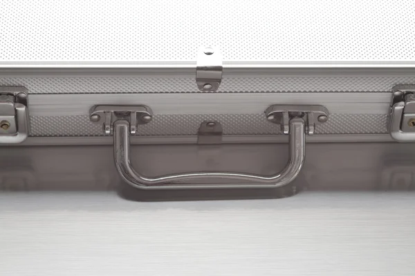 Metallic suitcase on gray background
