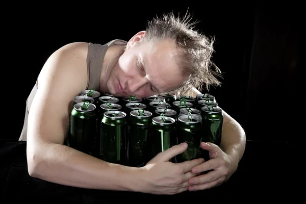 Hangover.The drunk man and is a lot of empty beer cans