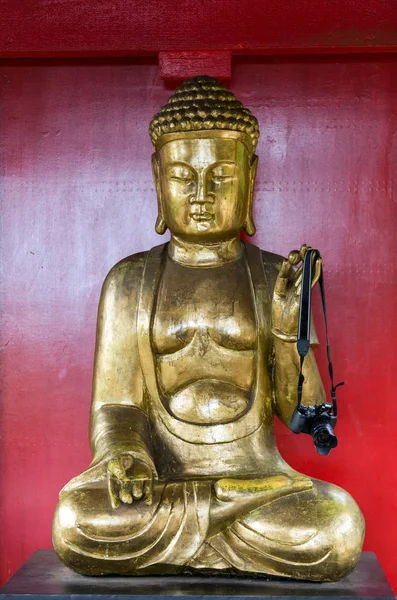 Buddha statue with camera on Monte Palace Tropical Garden, Funchal, Madeira, Portugal