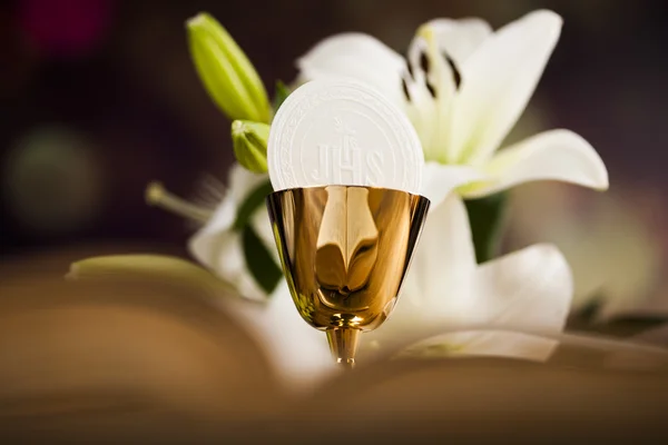 Holy communion and a golden chalice with flowers