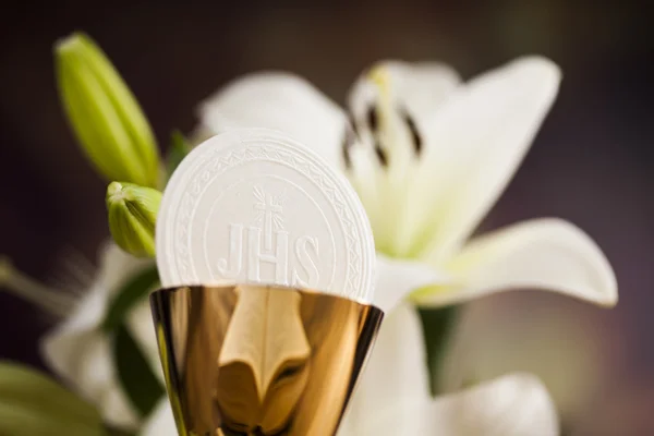 Holy communion and a golden chalice with flowers