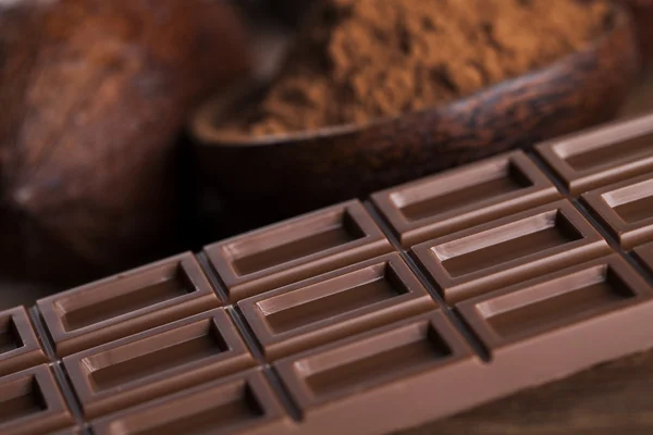 Chocolate bars, cacao beans and powder