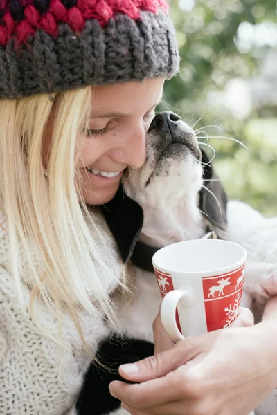 Woman and her puppy drinking together