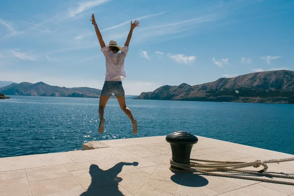 Happy woman jumping on vacation