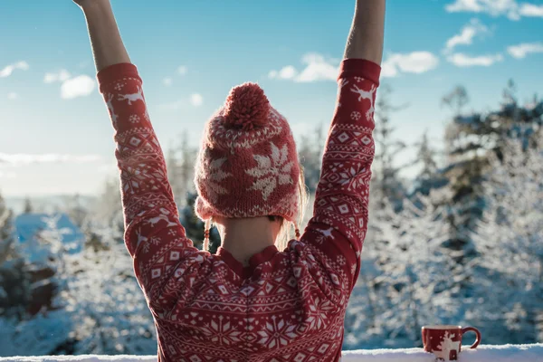 Morning stretch, carefree young woman on snow covered balcony