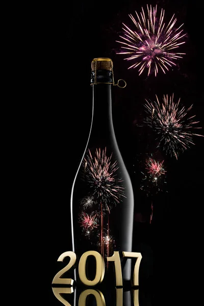 New Year concept.Champagne wine bottle 2017 on black background