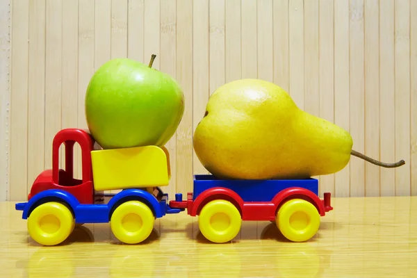 Toy plastic car with apple and pear