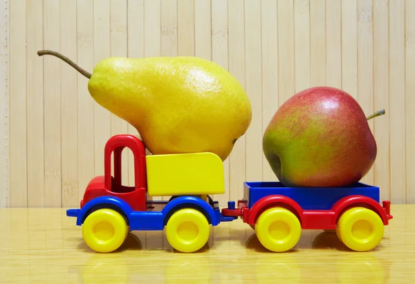 Toy plastic car with apple and pear