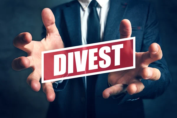 Divestment concept with businessman in suite