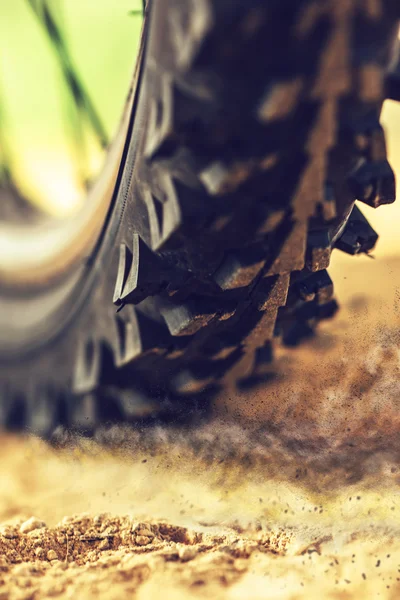 Mountain bike wheel close up with dirt dust particles