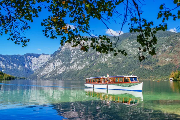 Tourists sightseeing Bohinj lake and surrounding from boat