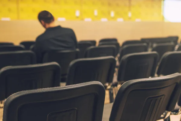 Unrecognizable journalist in press conference room