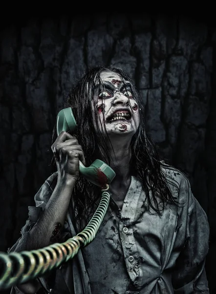 Horror zombie girl calling by phone
