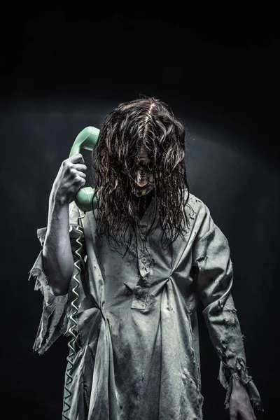 Horror zombie girl calling by phone