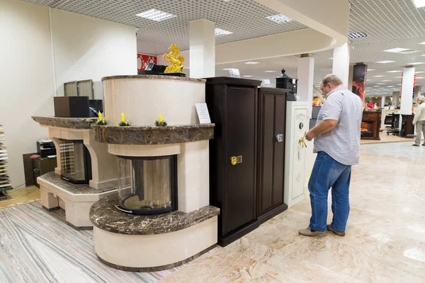 Khimki, Russia - September 03.2016. The buyer chooses metal safes in largest furniture store Grand